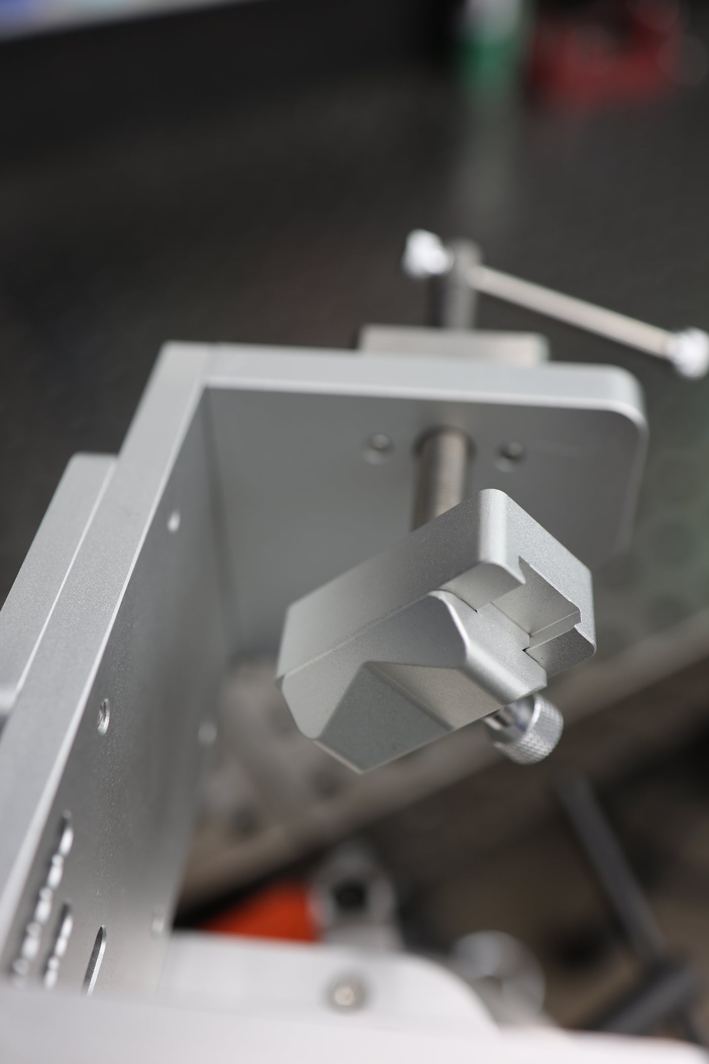Close-up of the adjustable rotating V-block clamp that centers bends and pie cuts for precise spin