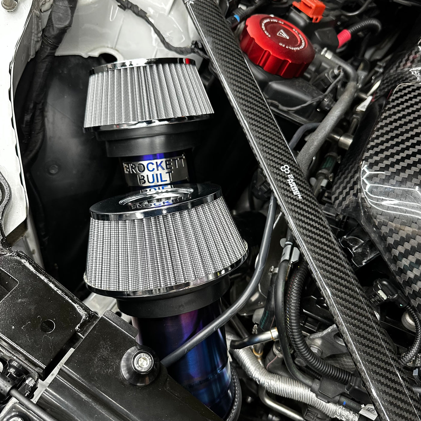 G80 titanium intake close-up showing weld and machined bung