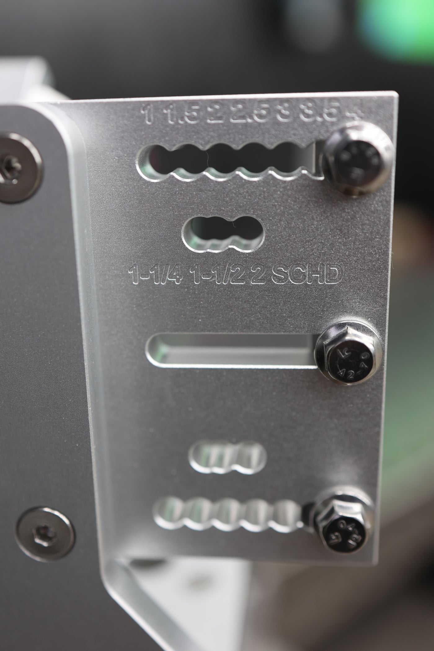 Engraved tube size index on the Brockett Built Tube Fixture showing 1, 1.5, 2, 2.5, 3, 3.5, 4 inch and 1-1/4, 1-1/2, 2 inch schedule pipe detent positions