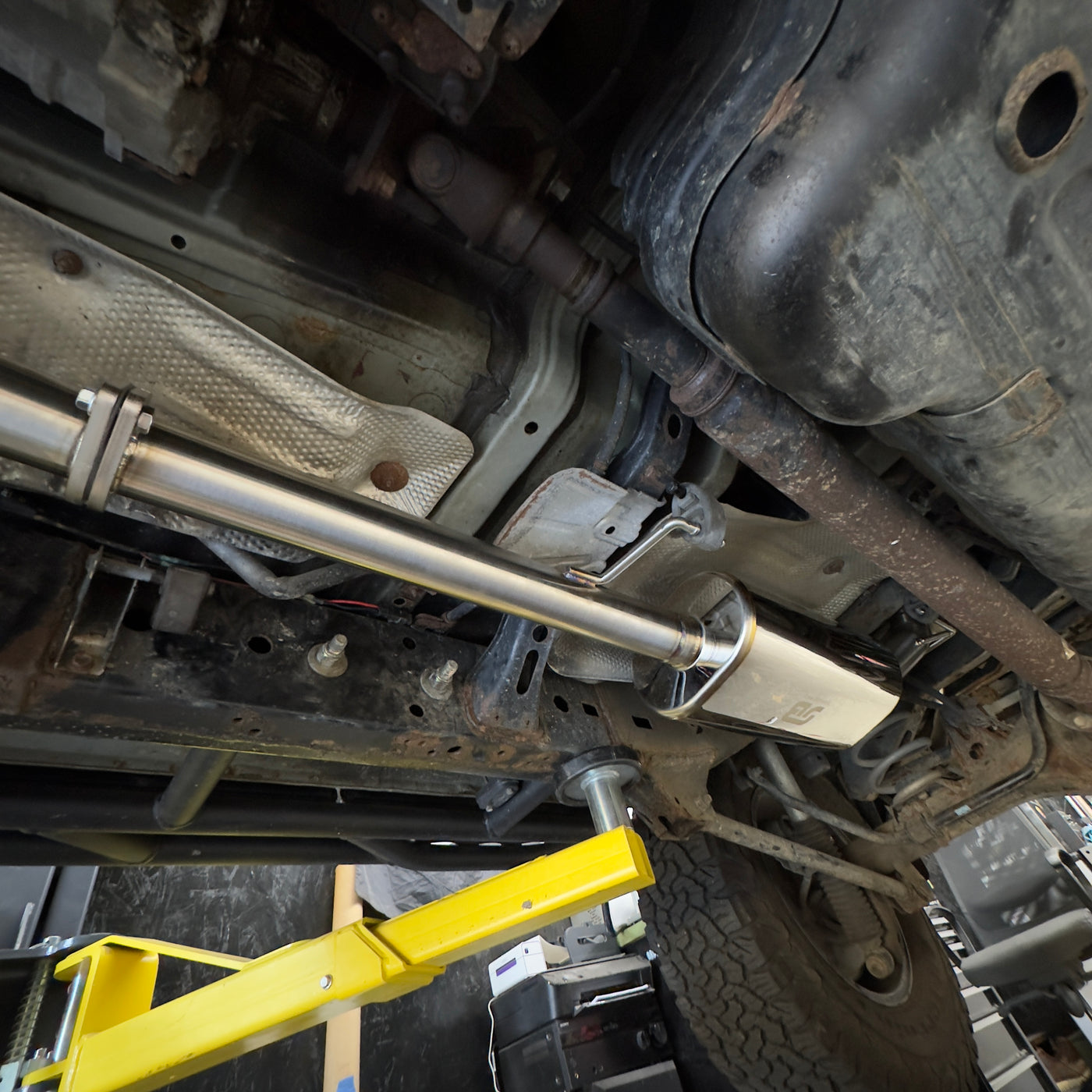 Modular catback exhaust side exit option behind passenger tire