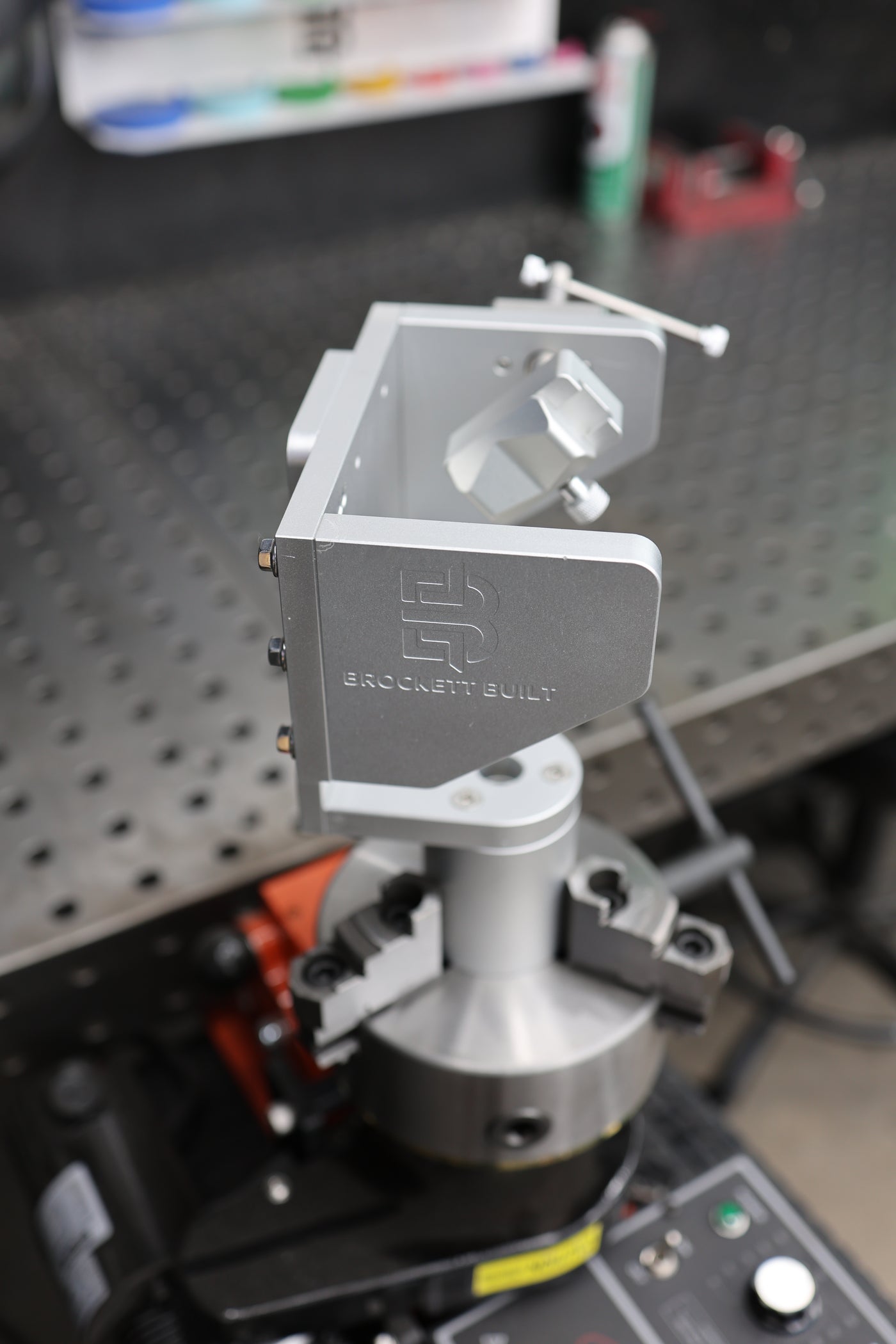 Side profile of the clear-anodized aluminum Tube Fixture with engraved Brockett Built logo