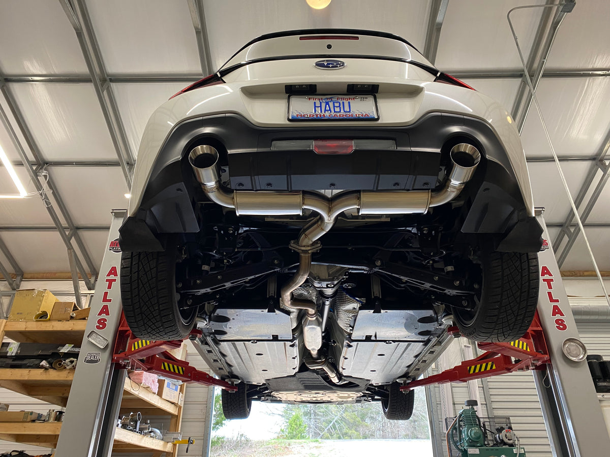 2022+ Subaru BRZ / Toyota GR86 on the lift with the Brockett Built dual-exit axle-back exhaust installed, rear view