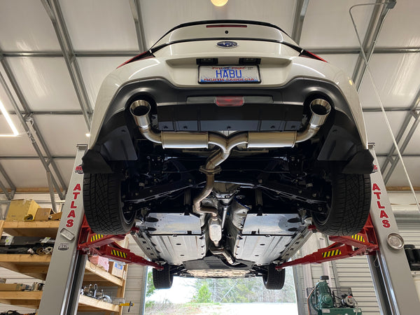 Subaru BRZ on the lift with a Brockett Built dual-exit axle-back exhaust installed