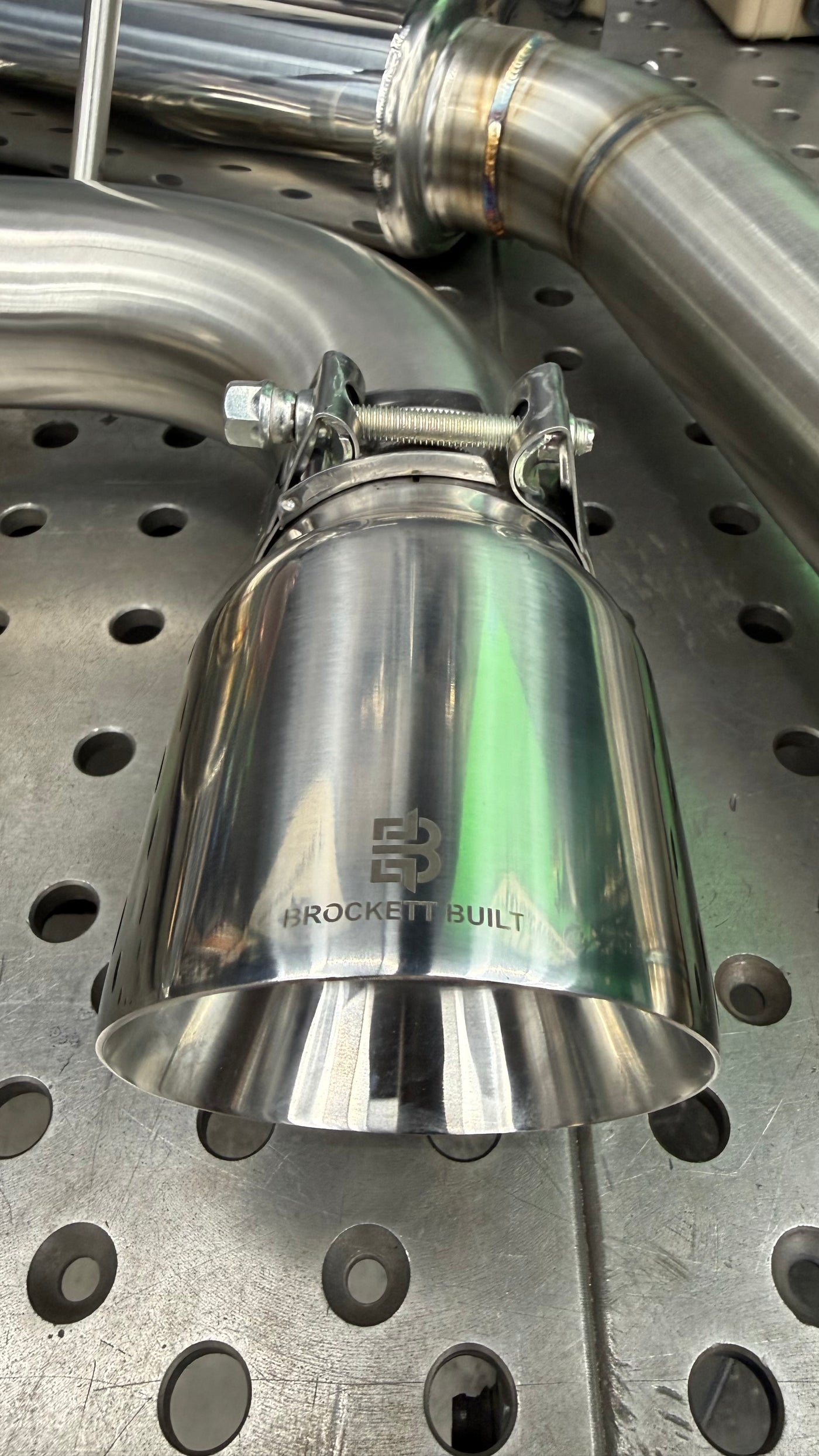 Jones double wall slant cut exhaust tip with laser etched Brockett Built logo on the GTI Stealth cat-back