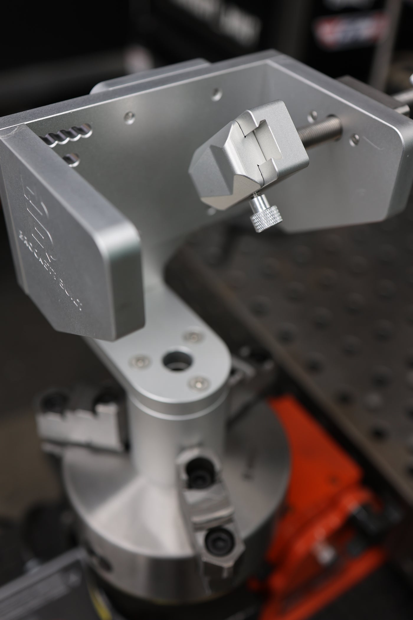 Top-down view of the pivoting V-block and knurled thumbscrew on the Tube Fixture