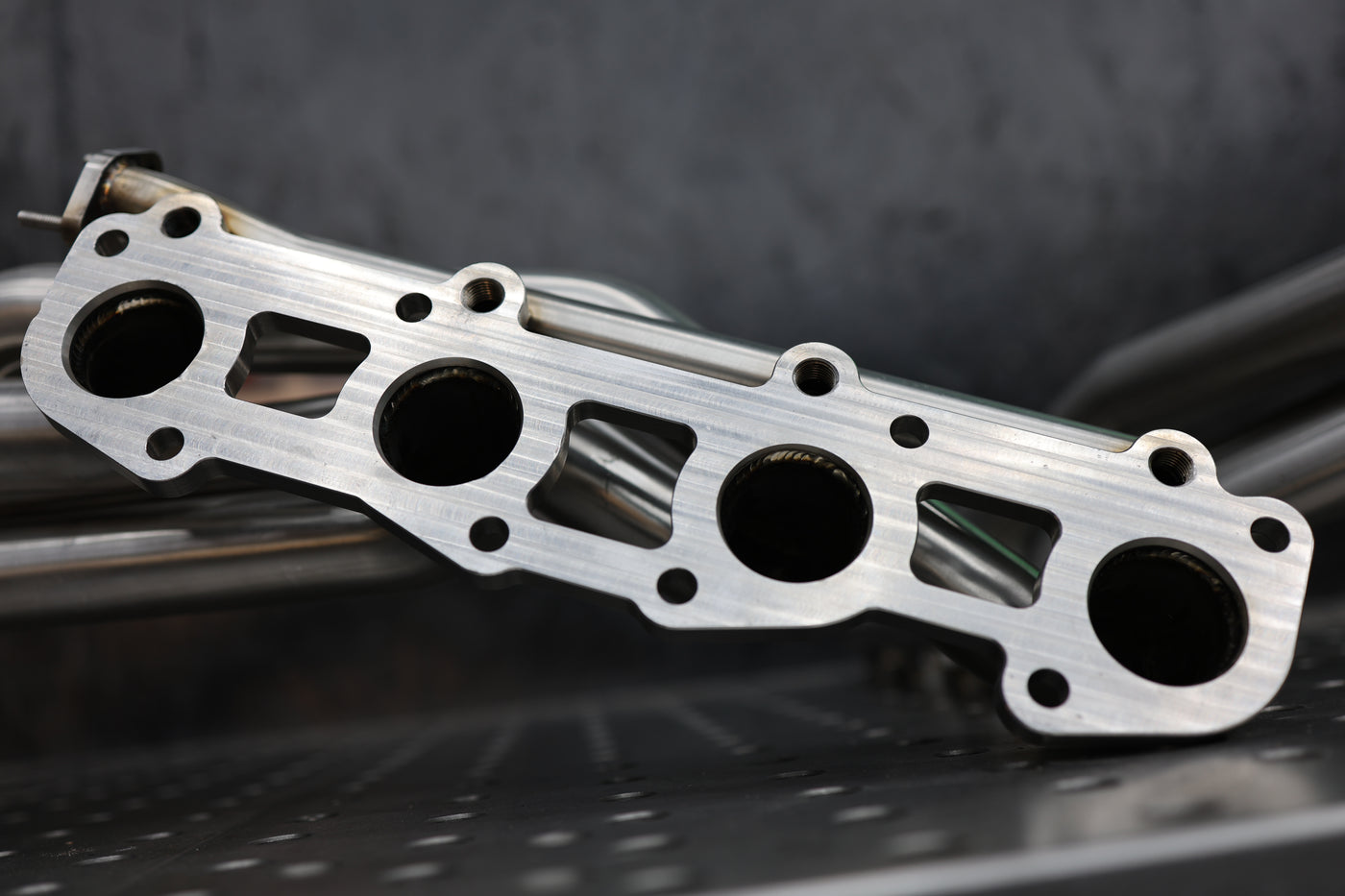 GX470 headers installed close-up at cylinder head flange