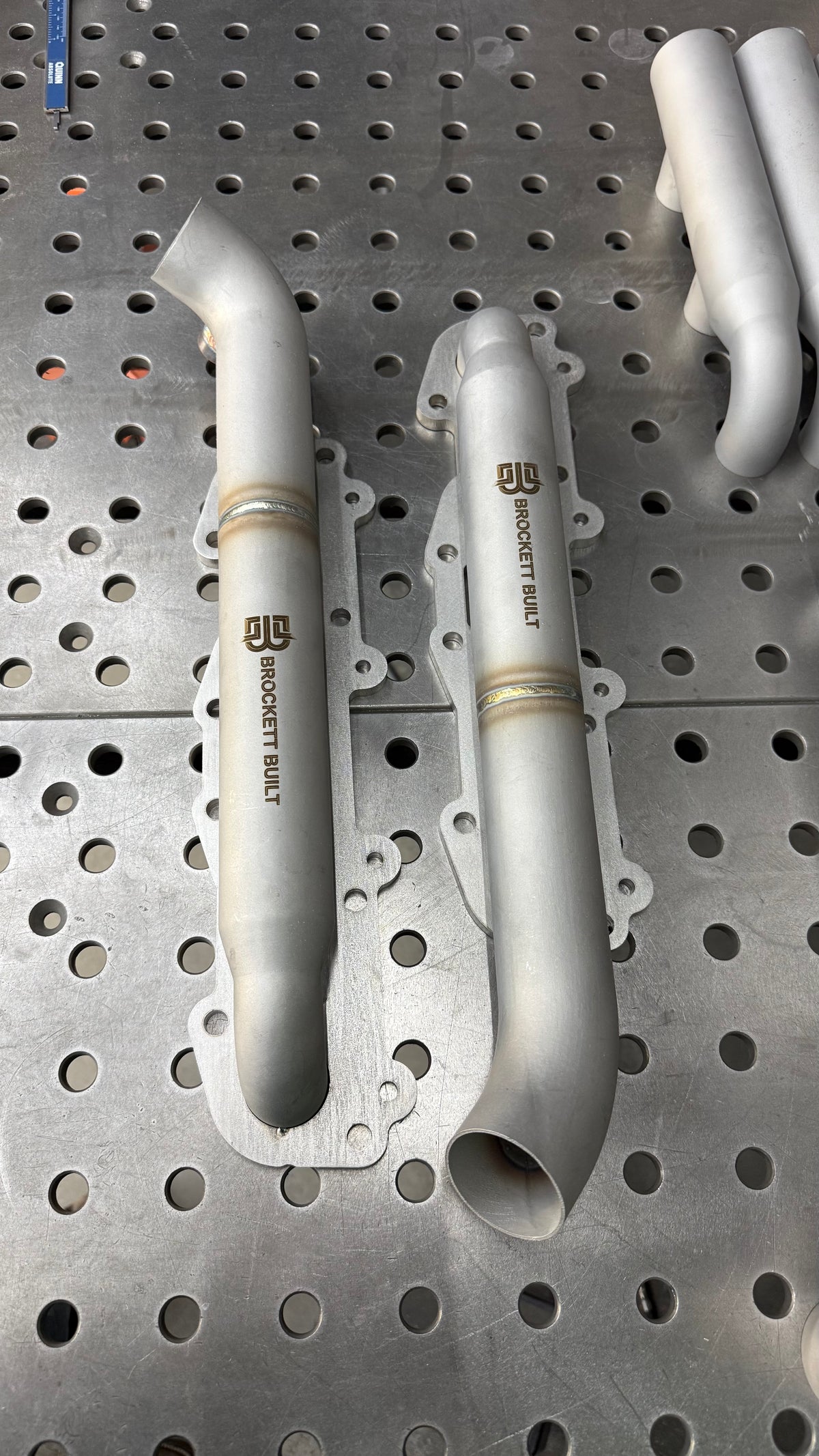 Top view of a pair of 3D printed 2UZ-FE log manifolds with 2in logs and the Brockett Built logo