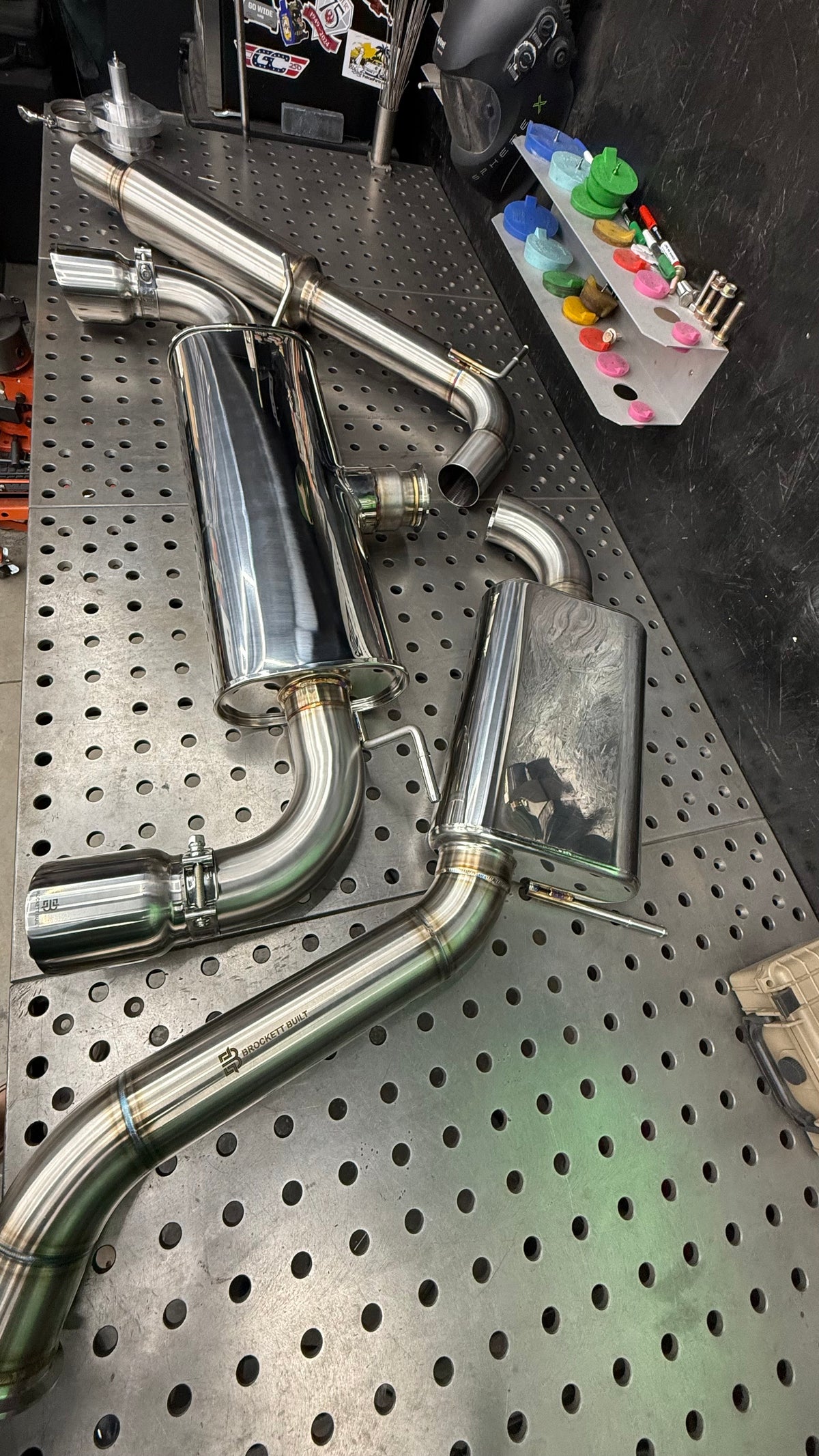 Rear muffler and axle-back section of the Brockett Built GTI Stealth cat-back with the laser etched logo on 304 stainless tubing