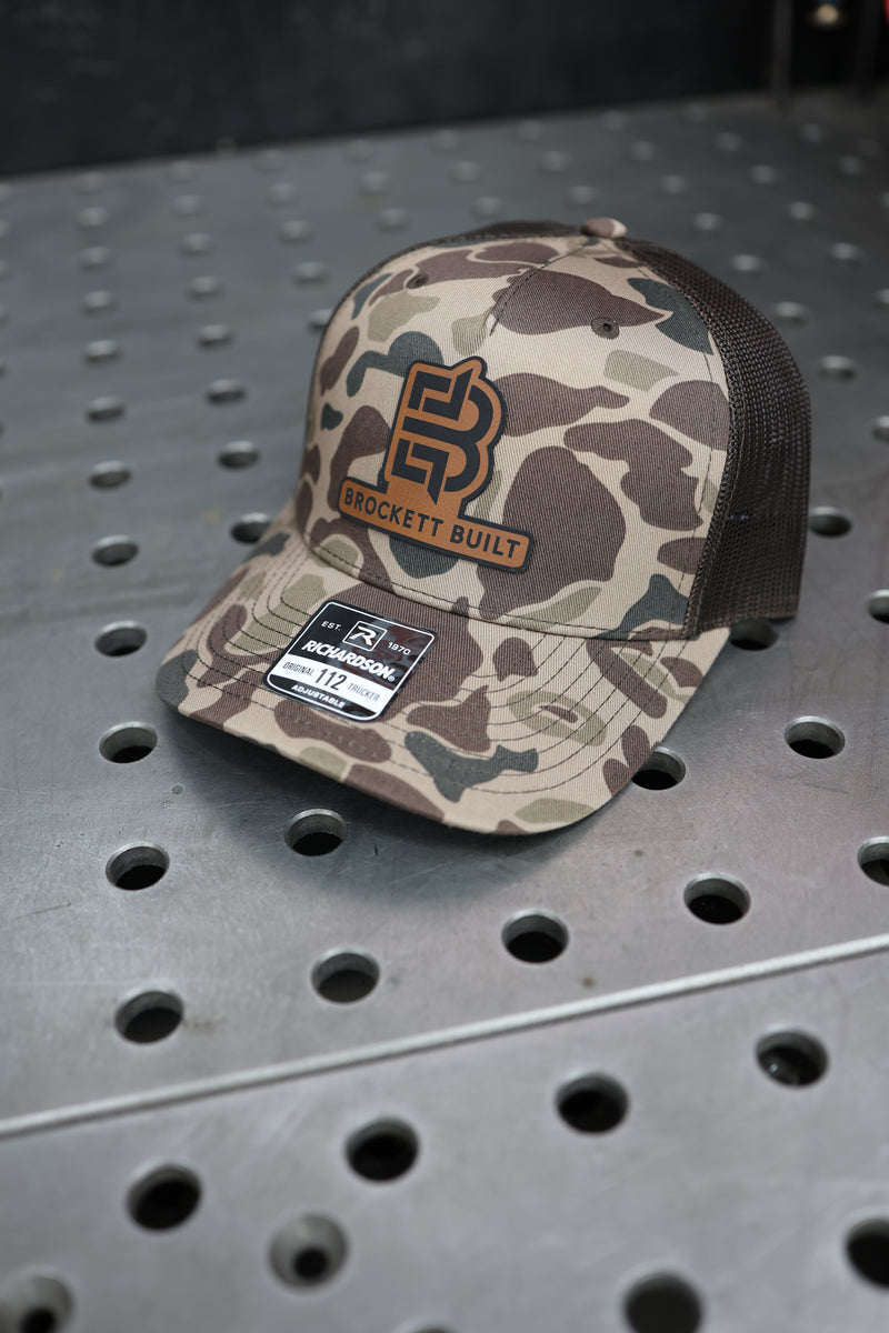 Brockett Built 112-PFP trucker snapback in Bark Duck Camo with brown brim
