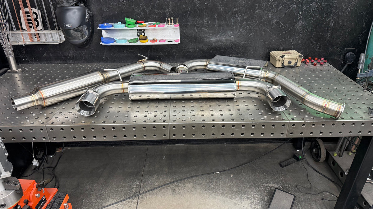 Full Stealth cat-back system for the VW GTI showing the resonator, front oval muffler, rear transverse muffler and dual slant cut tips