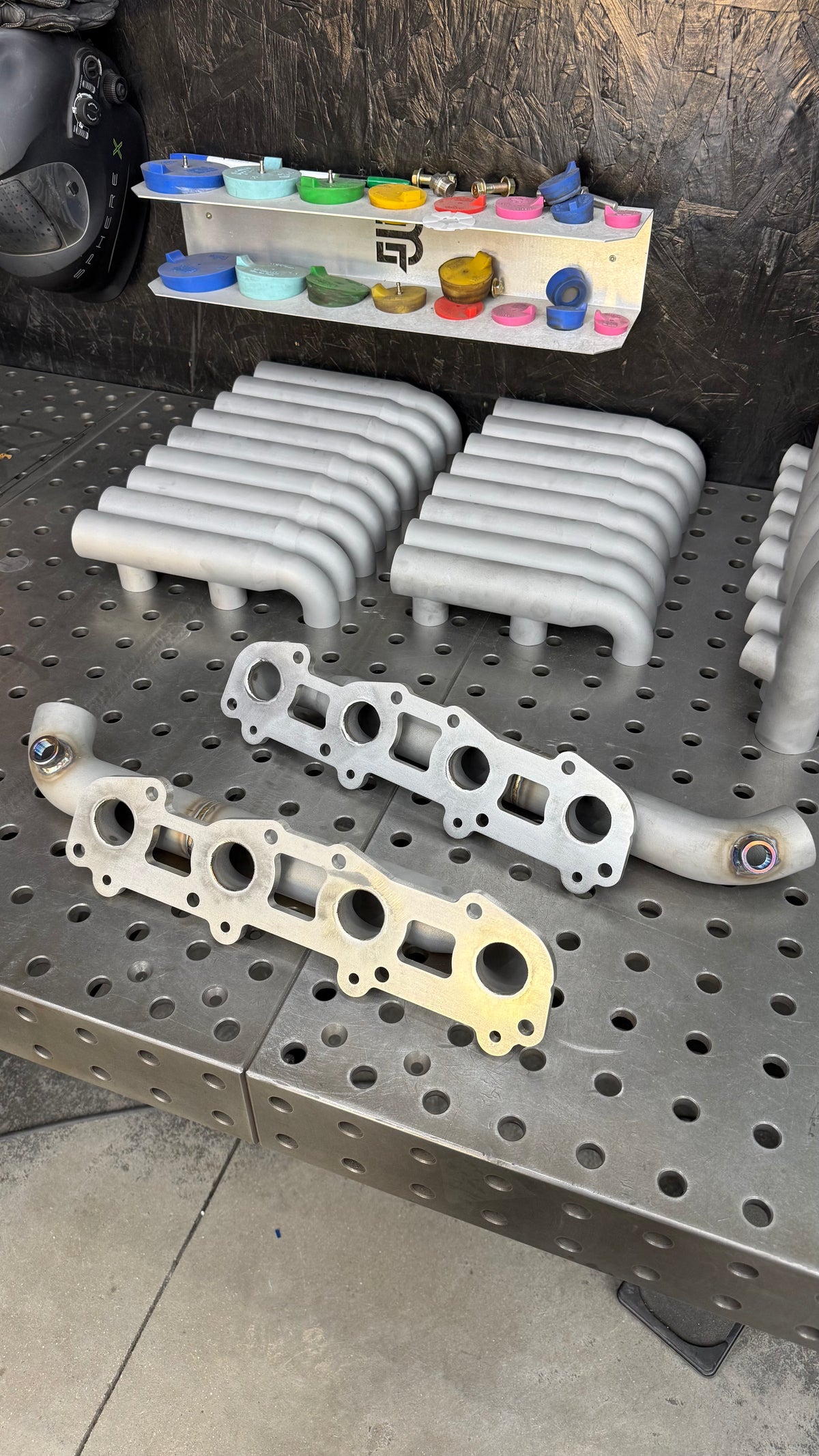 Flange side of 2UZ-FE log manifolds showing the exhaust ports and bolt holes