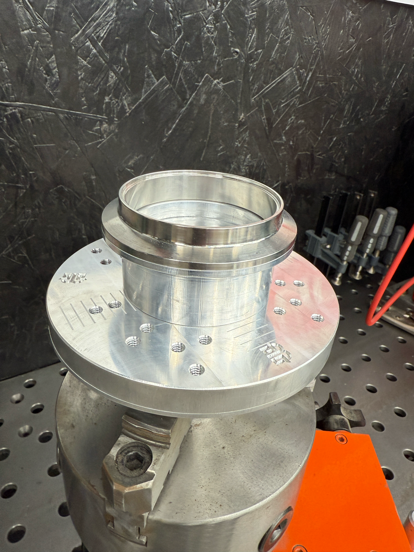 V-band adapter in use on flange welding fixture securing V-band flange