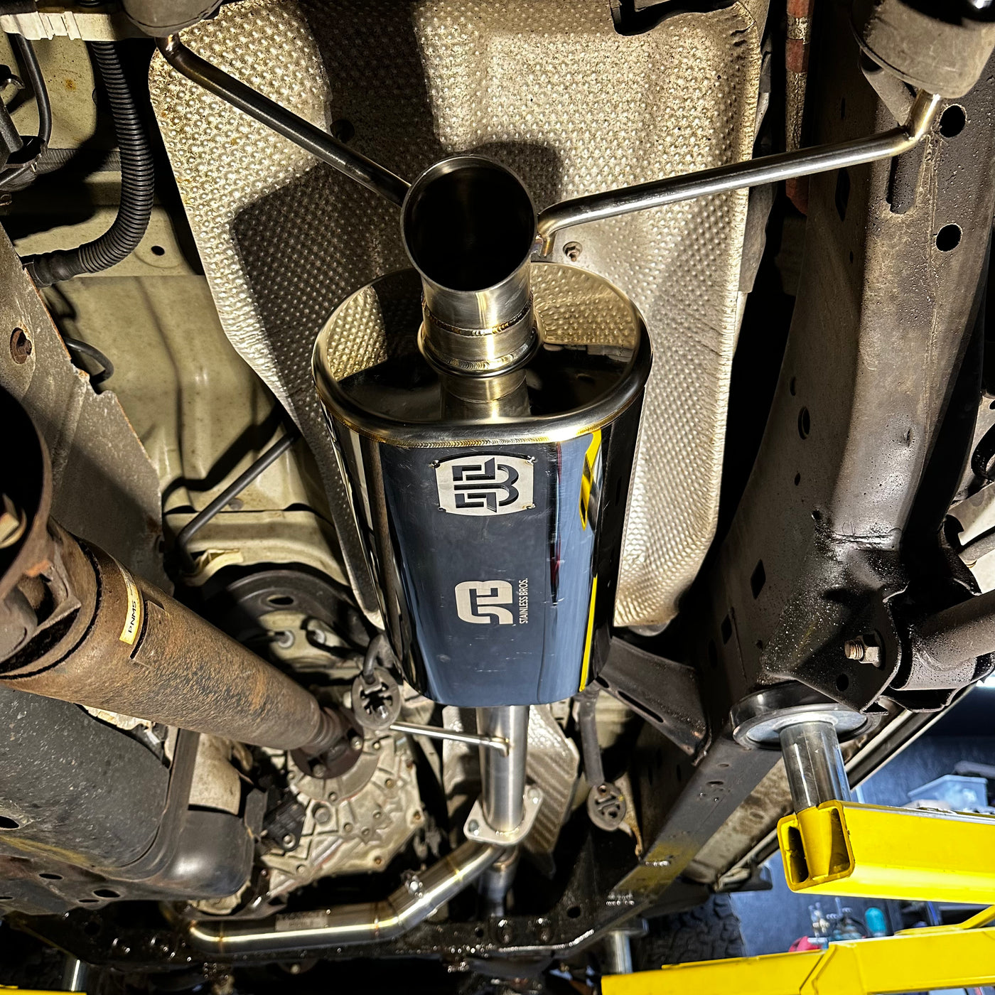 Muffler dump pipe showing inlet flange connection