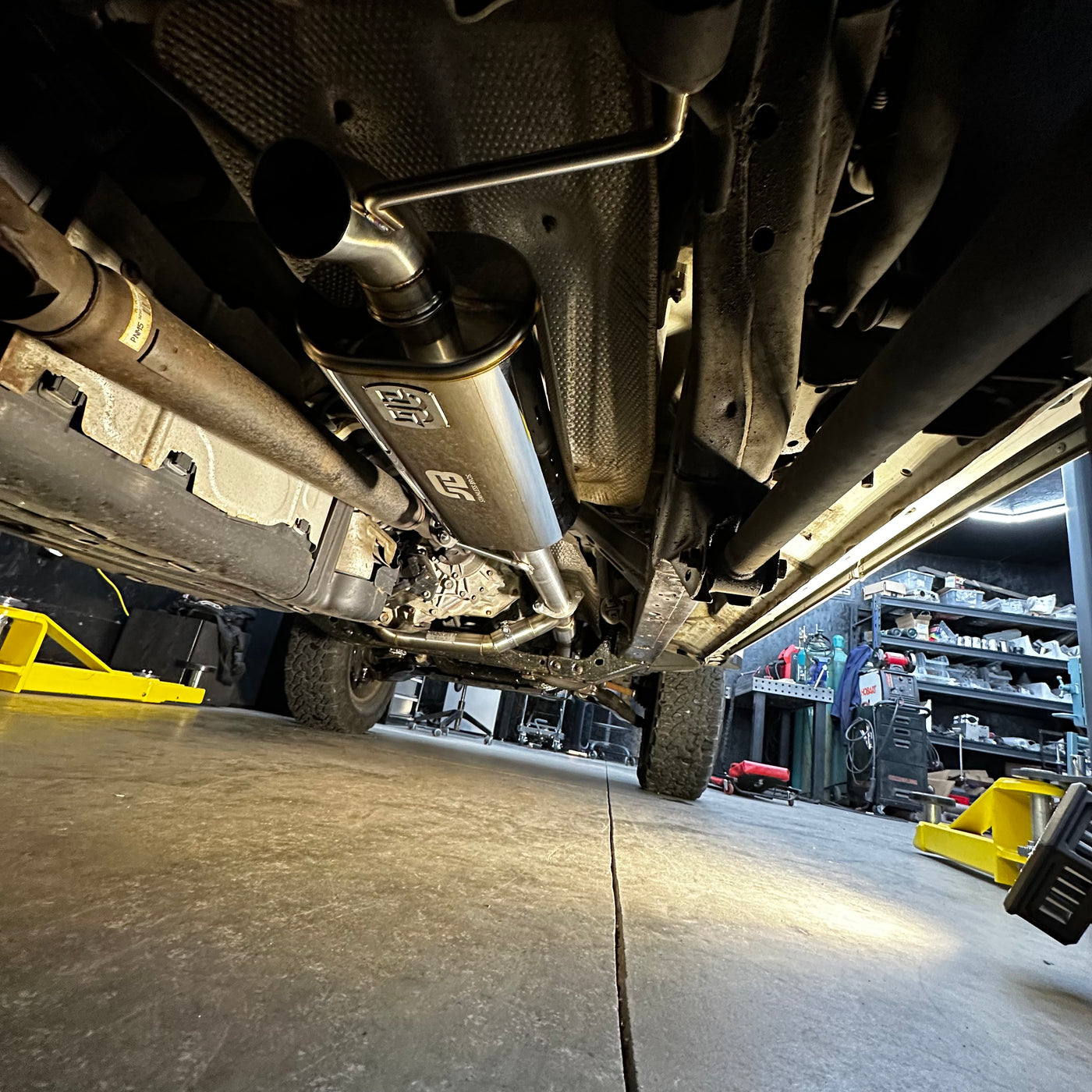 Muffler dump pipe side profile view showing high-clearance design