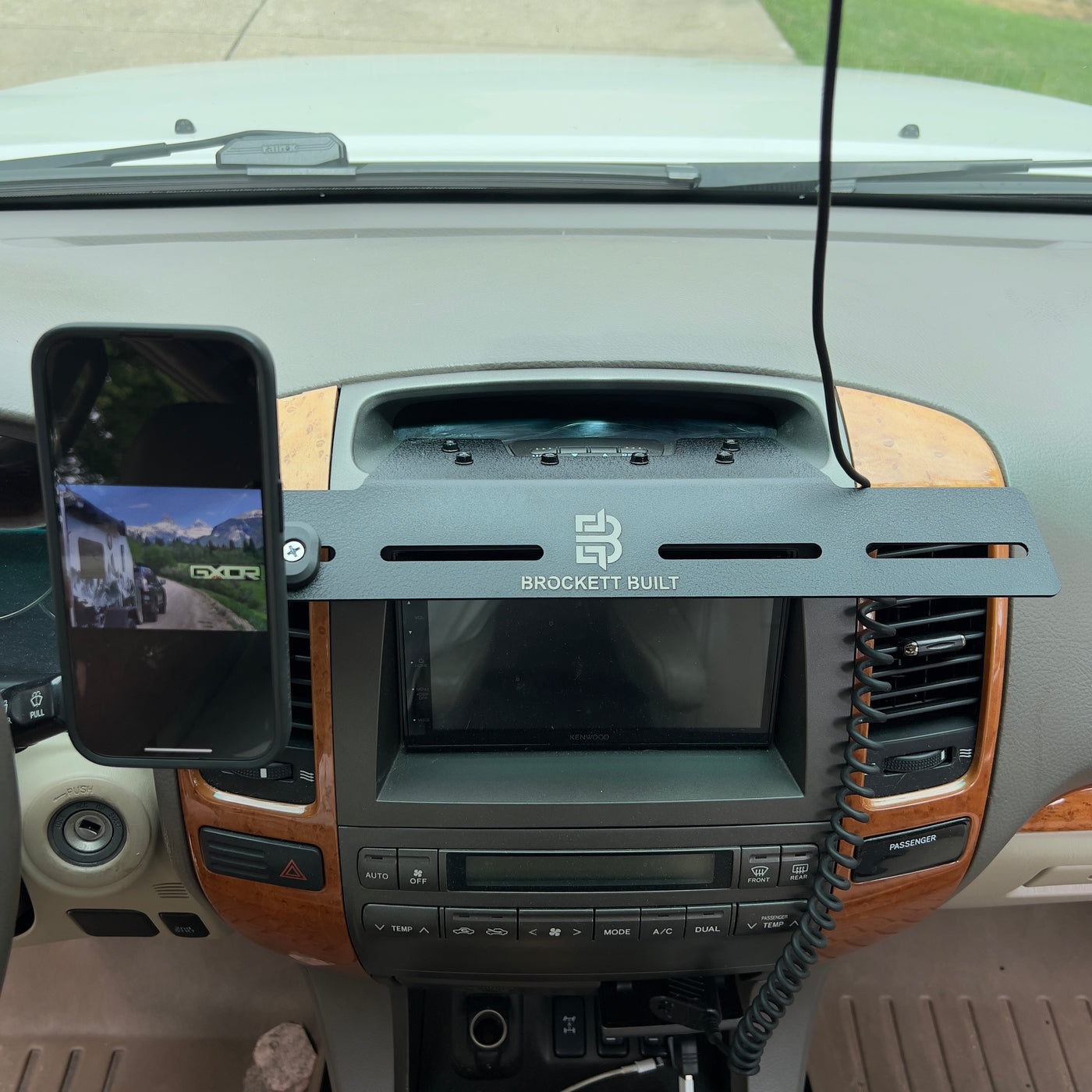 GX470 MOLLE dash mount installed on dashboard with phone holder attached