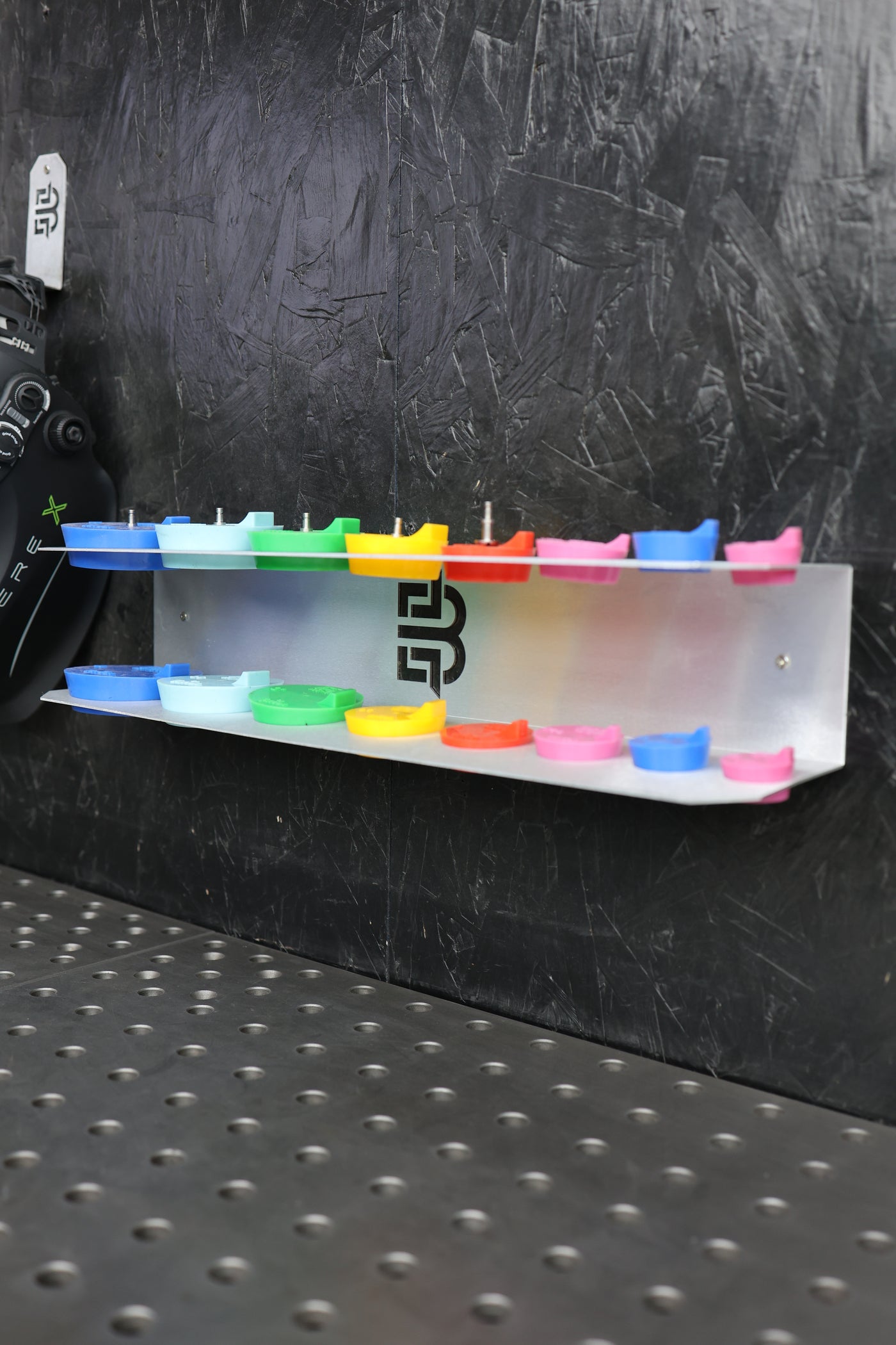Purge plug bracket with plugs stored on shop wall
