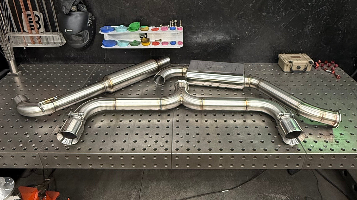 Brockett Built Aggressive cat-back for the VW GTI on the welding table in the Bartonville, Illinois shop