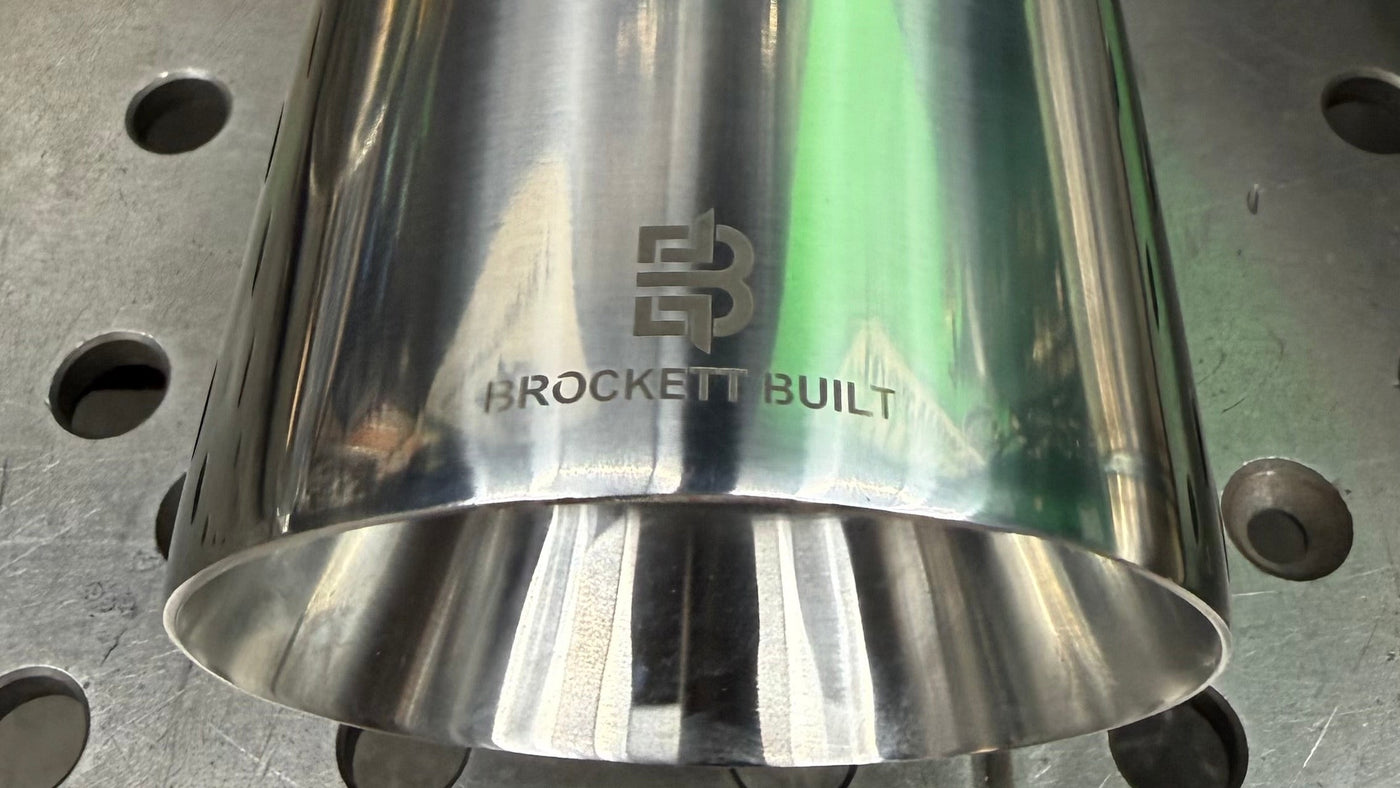 Jones 4 inch double wall slant cut exhaust tip with laser etched Brockett Built logo on the Mk7 GTI Stealth cat-back