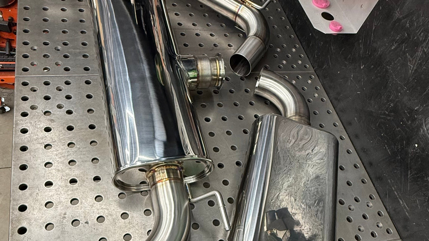 Rear transverse muffler and front oval muffler of the Brockett Built Stealth cat-back for the Mk7 and Mk7.5 GTI, 304 stainless with V-band joint