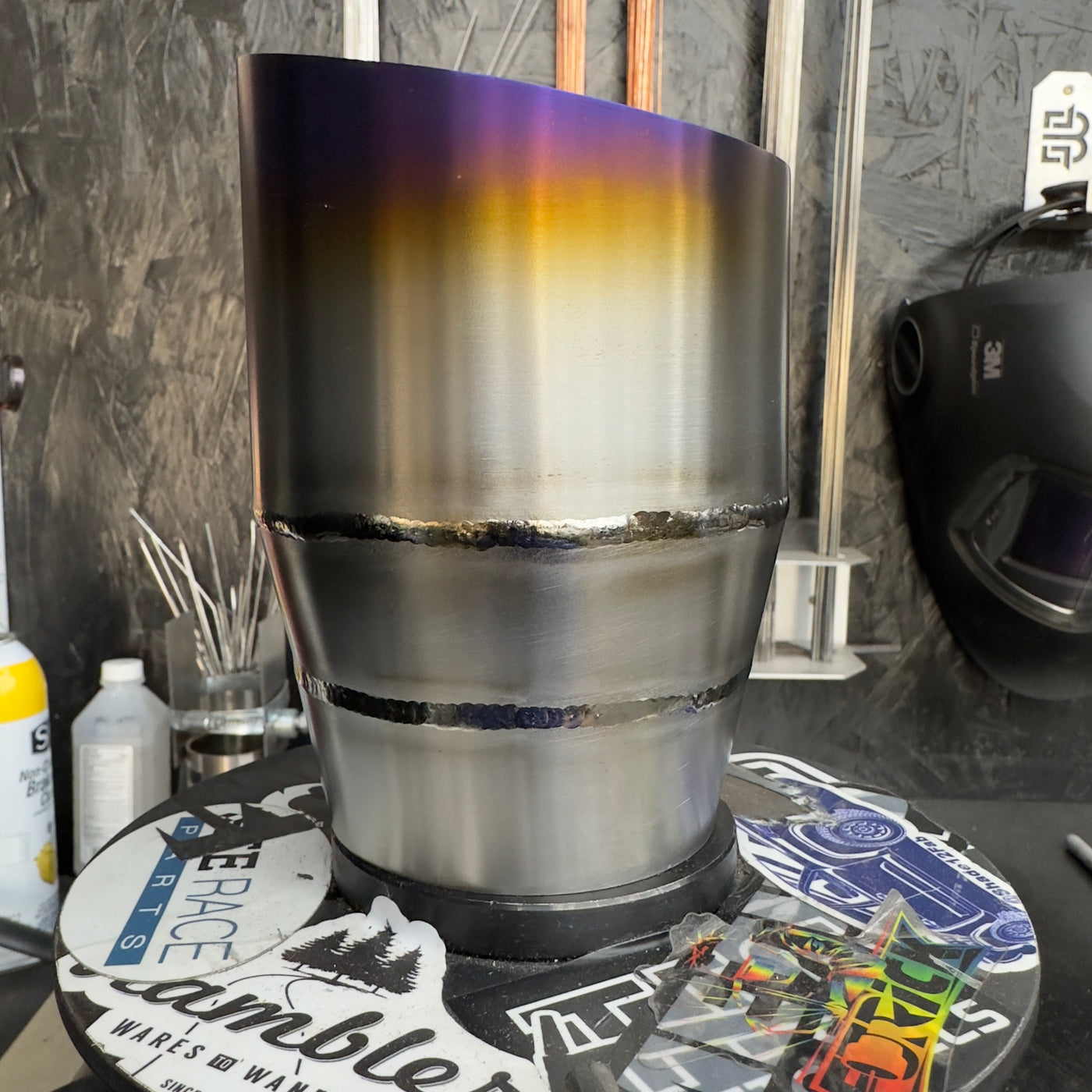 Titanium exhaust tip close-up showing iridescent burnt finish